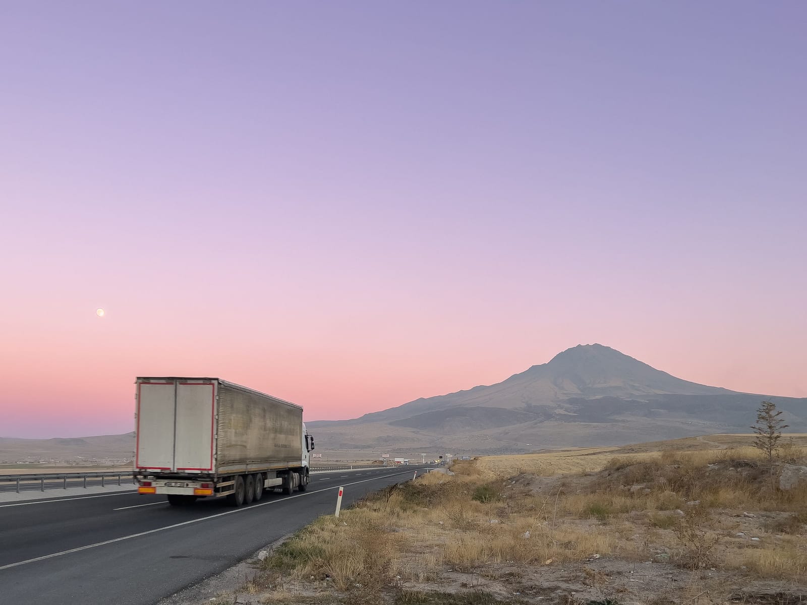 Truck on an empty road at dusk
